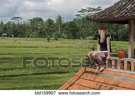 Caucasian woman overlooking rural fields from balcony View Large Photo Image Stock Photo - Caucasian woman overlooking rural fields from balcony. Fotosearch