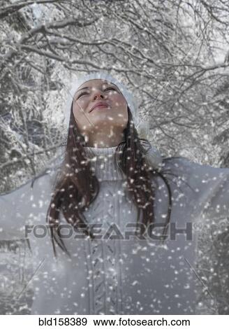 Stock Photo - Caucasian woman playing in snow. Fotosearch
