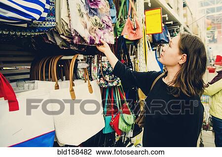 Caucasian woman shopping for purse in store View Large Photo Image Stock Image - Caucasian woman shopping for purse in store. Fotosearch