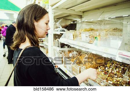 Caucasian woman shopping in grocery store View Large Photo Image Stock Photograph - Caucasian woman shopping in grocery store. Fotosearch