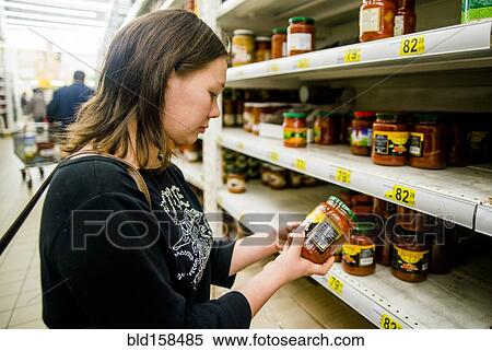 Stock Photography - Caucasian woman shopping in grocery store. Fotosearch