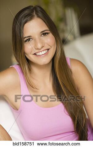 Caucasian woman with long hair sitting on sofa View Large Photo Image Stock Image - Caucasian woman with long hair sitting on sofa. Fotosearch