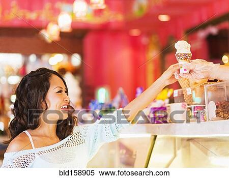 Chinese woman buying ice cream cone in shop View Large Photo Image Stock Photography - Chinese woman buying ice cream cone in shop. Fotosearch