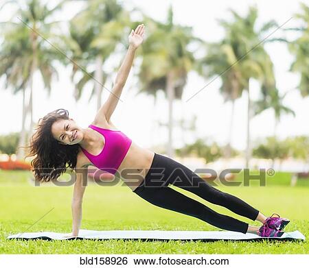 Chinese woman practicing yoga in park View Large Photo Image Stock Photograph - Chinese woman practicing yoga in park. Fotosearch