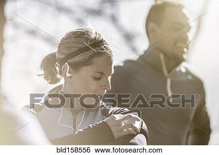 Close up of athlete using mp3 player View Large Photo Image Stock Photograph - Close up of athlete using mp3 player. Fotosearch
