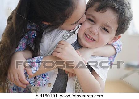 Close up of Caucasian girl kissing brother View Large Photo Image Stock Image - Close up of Caucasian girl kissing brother. Fotosearch