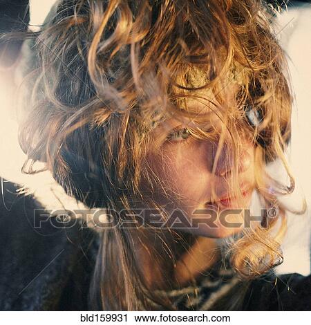 Stock Image - Close up of Caucasian girl with messy curly hair. Fotosearch