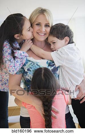 Close up of Caucasian mother and children hugging View Large Photo Image Stock Photograph - Close up of Caucasian mother and children hugging. Fotosearch