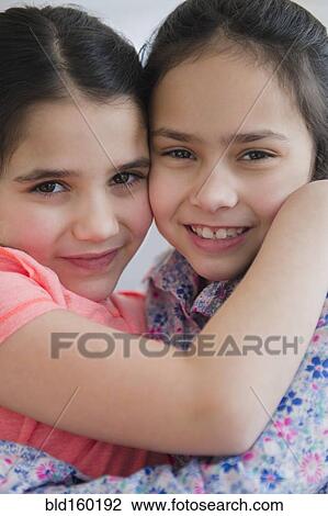 Close up of Caucasian sisters hugging View Large Photo Image Stock Image - Close up of Caucasian sisters hugging. Fotosearch
