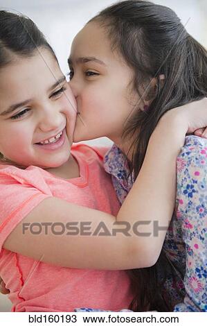 Close up of Caucasian sisters kissing View Large Photo Image Stock Image - Close up of Caucasian sisters kissing. Fotosearch