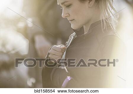 Close up of Caucasian woman zipping jacket View Large Photo Image Picture - Close up of Caucasian woman zipping jacket. Fotosearch