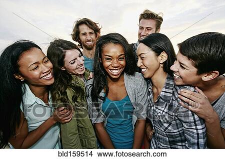 Picture - Close up of friends laughing outdoors. Fotosearch