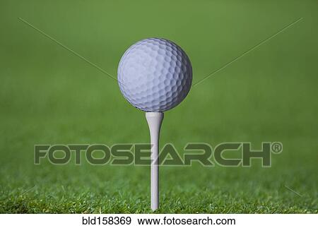 Stock Photo - Close up of golf ball on tee. Fotosearch