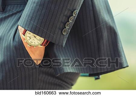 Stock Image - Close up of hand in pocket of Caucasian businessman. Fotosearch