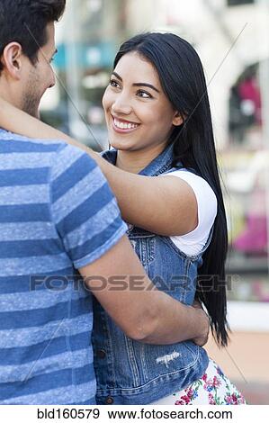 Stock Photo - Close up of Hispanic couple hugging. Fotosearch