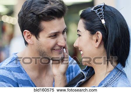 Stock Photography - Close up of Hispanic couple hugging. Fotosearch