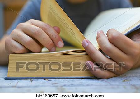 Close up of Hispanic man turning book pages View Large Photo Image Stock Photo - Close up of Hispanic man turning book pages. Fotosearch