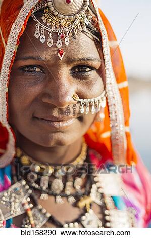 Stock Image - Close up of Indian woman wearing traditional jewelry. Fotosearch