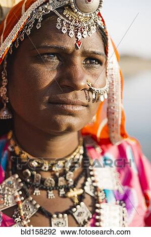 Stock Image - Close up of Indian woman wearing traditional jewelry. Fotosearch