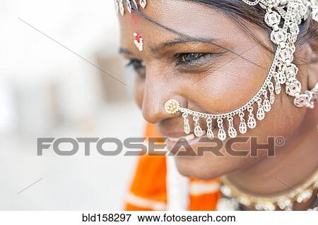 Stock Photo - Close up of Indian woman wearing traditional jewelry. Fotosearch
