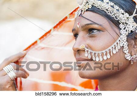 Close up of Indian woman wearing traditional jewelry View Large Photo Image Stock Photograph - Close up of Indian woman wearing traditional jewelry. Fotosearch