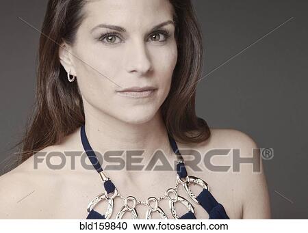 Stock Image - Close up of mixed race woman wearing evening gown. Fotosearch