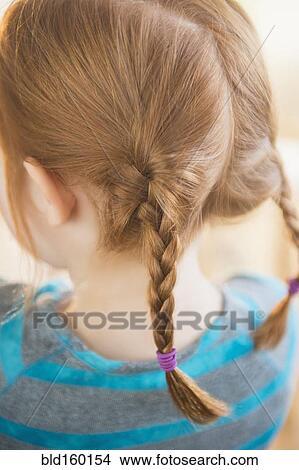Picture - Close up of red hair of Caucasian girl in pigtails. Fotosearch