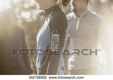 Stock Image - Close up of runner wearing mp3 player. Fotosearch