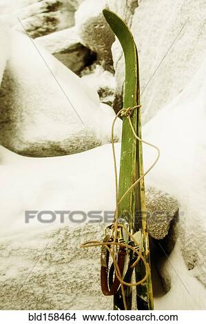 Picture - Close up of skis leaning on snowy rock formations. Fotosearch