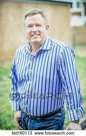 Close up of smiling Caucasian man standing outdoors View Large Photo Image Stock Image - Close up of smiling Caucasian man standing outdoors. Fotosearch