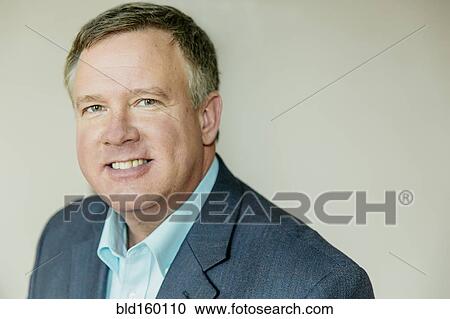 Stock Image - Close up of smiling Caucasian businessman. Fotosearch