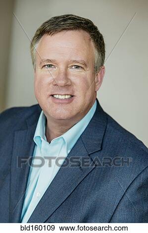 Stock Photo - Close up of smiling Caucasian businessman. Fotosearch