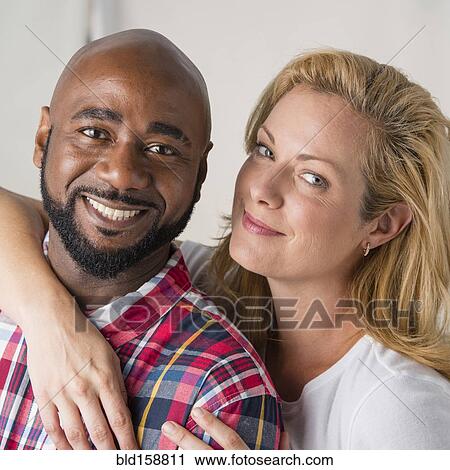 Close up of smiling couple hugging View Large Photo Image Stock Image - Close up of smiling couple hugging. Fotosearch