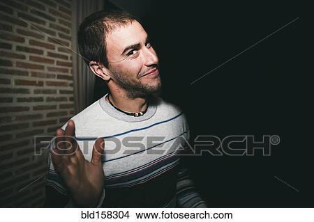 Close up of smiling man waving at night View Large Photo Image Picture - Close up of smiling man waving at night. Fotosearch