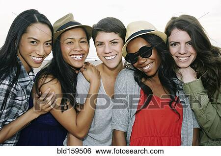 Stock Photograph - Close up of women smiling outdoors. Fotosearch