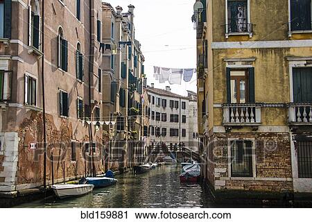 Clotheslines over canal between apartment buildings, Venice, Italy View Large Photo Image Stock Image - Clotheslines over canal between apartment buildings, Venice, Italy. Fotosearch