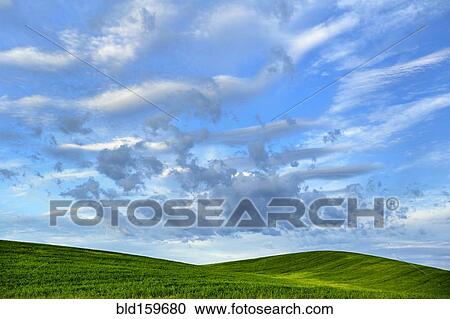 Cloudy sky over rural rolling hills View Large Photo Image Stock Image - Cloudy sky over rural rolling hills. Fotosearch
