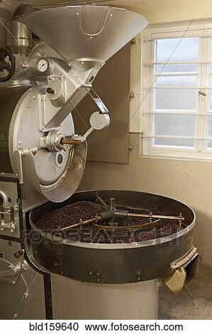 Stock Image - Coffee beans roasting in industrial kettle. Fotosearch