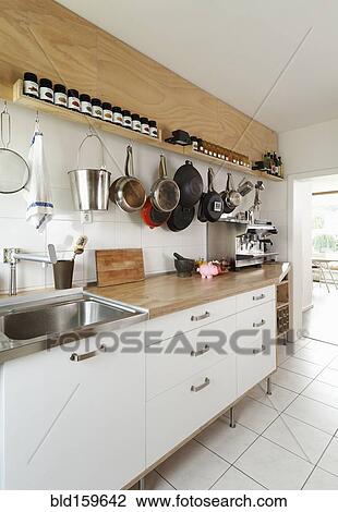 Stock Image - Counter space and cooking utensils in modern kitchen. Fotosearch