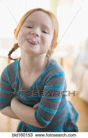 Defiant Caucasian girl sticking out tongue View Large Photo Image Stock Image - Defiant Caucasian girl sticking out tongue. Fotosearch