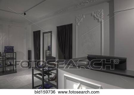 Stock Photograph - Dressing rooms and cash register behind empty store counter. Fotosearch