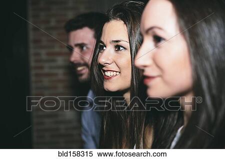 Stock Photography - Friends smiling in nightclub. Fotosearch