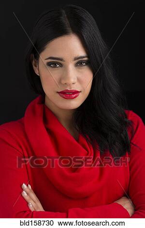 Stock Image - Glamorous Hispanic woman with arms crossed. Fotosearch