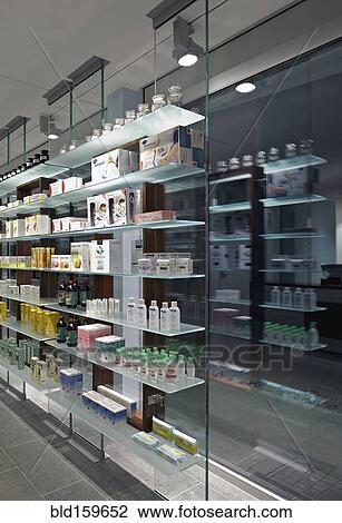 Stock Image - Glass shelves and windows in modern pharmacy. Fotosearch