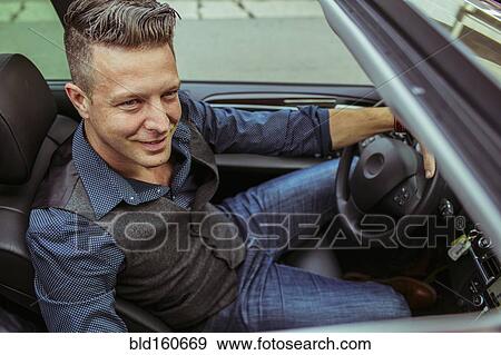 High angle view of Caucasian man driving car View Large Photo Image Stock Photo - High angle view of Caucasian man driving car. Fotosearch
