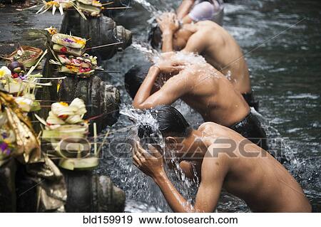 Stock Photo - High angle view of men washing in fountains. Fotosearch