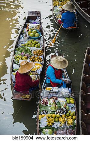 Picture - High angle view of merchants selling fruit in canoes. Fotosearch