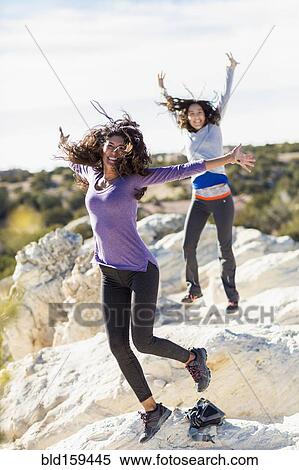 Hikers cheering on rocky hilltop View Large Photo Image Stock Photography - Hikers cheering on rocky hilltop. Fotosearch