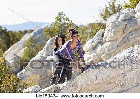 Picture - Hikers climbing rocky hillside. Fotosearch