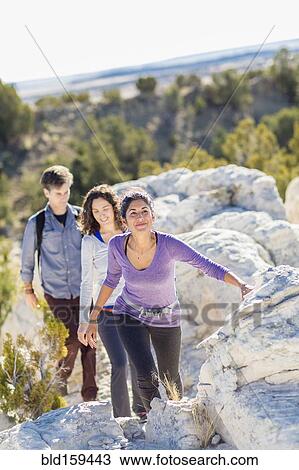 Hikers climbing rocky hillside View Large Photo Image Stock Image - Hikers climbing rocky hillside. Fotosearch